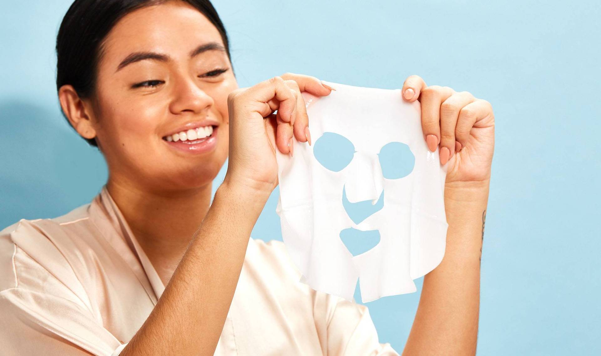 person holding up sheet mask