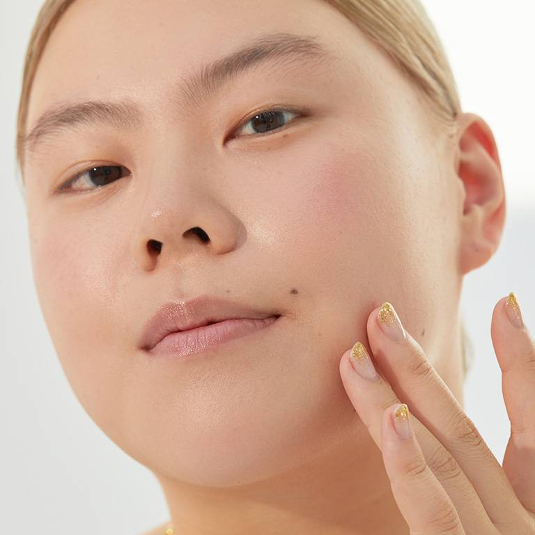 person posing with fingers on jawline